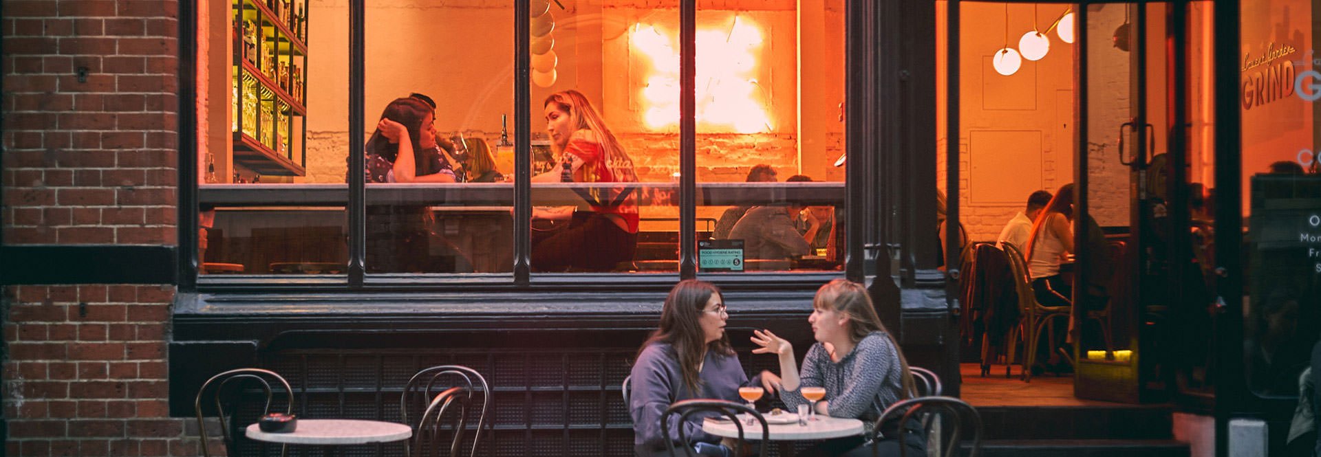 Two people sitting outside a venue