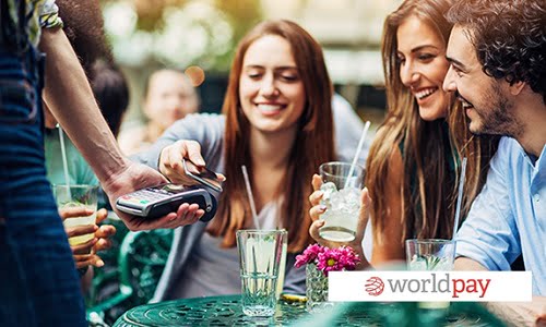 http://Friends%20enjoying%20a%20drink%20around%20a%20table%20and%20a%20lady%20making%20a%20contactless%20payment