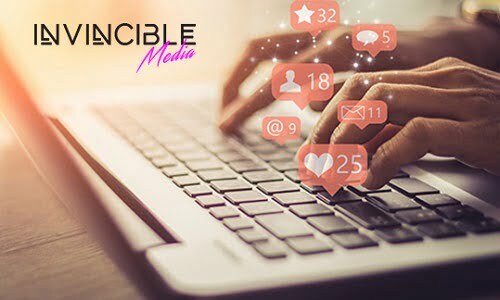 http://Person%20typing%20on%20a%20laptop%20&%20social%20media%20bubbles%20hovering%20over%20the%20persons%20hands