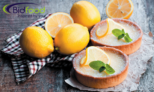 http://Two%20round%20lemon%20tarts,%20with%203%20whole%20lemons%20&%20one%20lemon%20cut%20in%20half%20on%20a%20chequered%20tea%20twoel